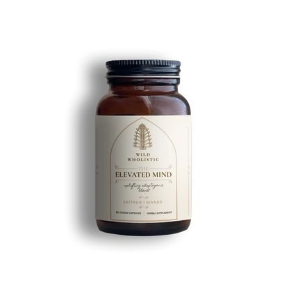 Supplement bottle 'Elevated Mind,' an uplifting adaptogenic blend by Wild Wholistic.